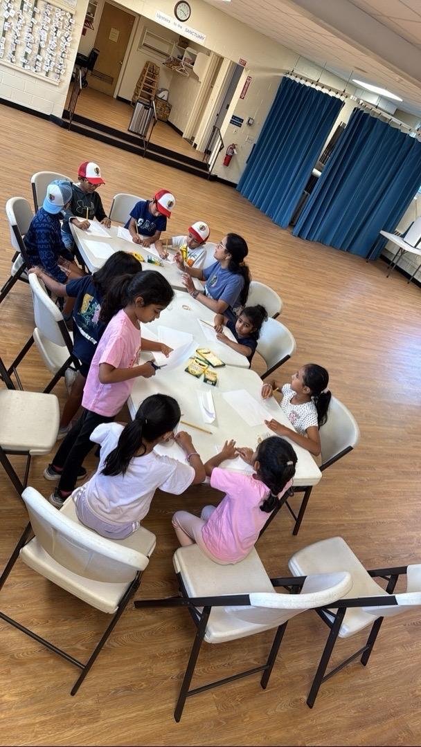 Kids working on creative projects at tables